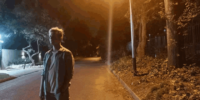 a person standing on a street at night