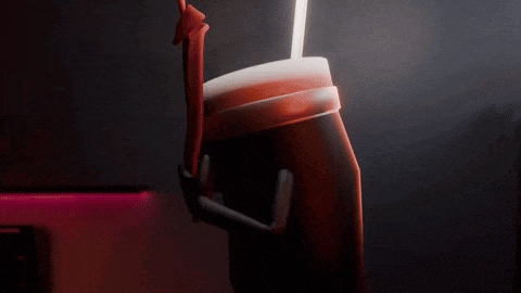a person is holding a cup with a straw in it .