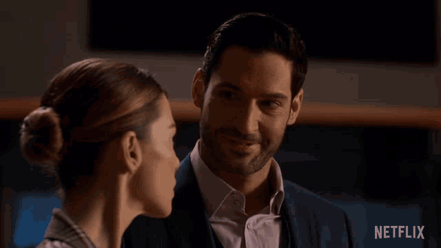 a man and woman are looking at each other with netflix written on the bottom right