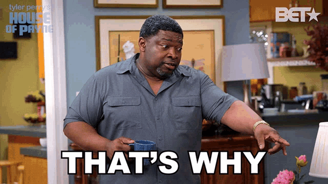 a man says that 's why while holding a blue cup