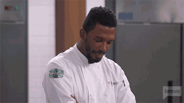 a man in a chef 's uniform with the word bravo on the bottom right