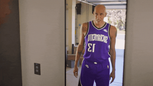 a basketball player in a purple jersey with the number 13 on it