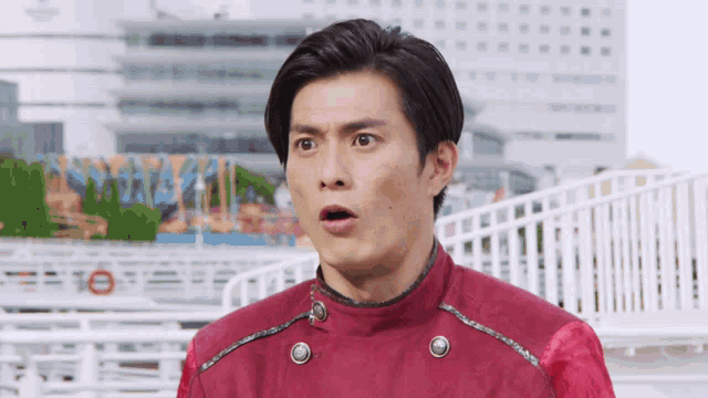 a man in a red jacket has his mouth open