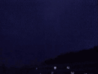 a lightning bolt is flying through a purple sky .