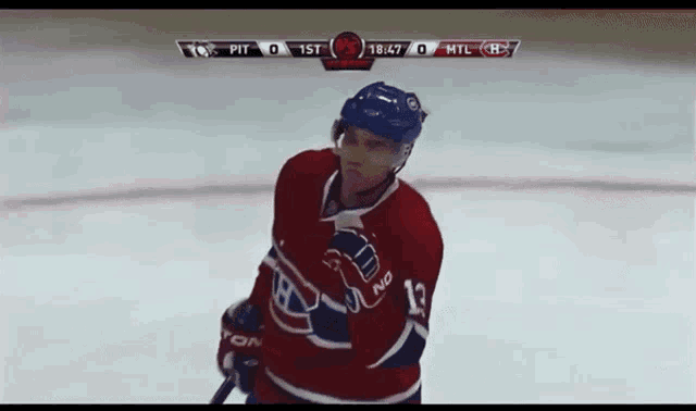 a hockey player in a red white and blue jersey with the number 12