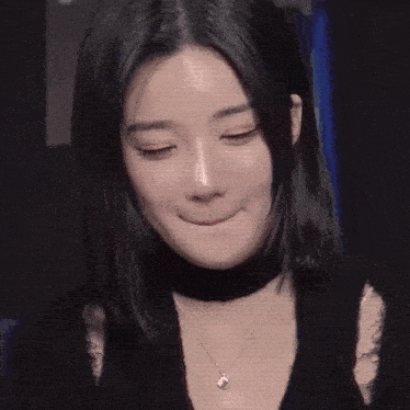 a close up of a woman 's face with long black hair