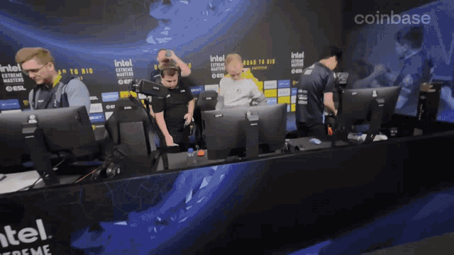 a group of people are sitting in front of a sign that says intel extreme masters