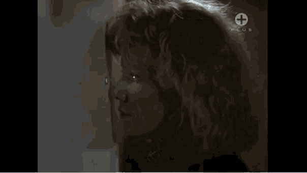 a close up of a woman 's face with a plus sign on the bottom