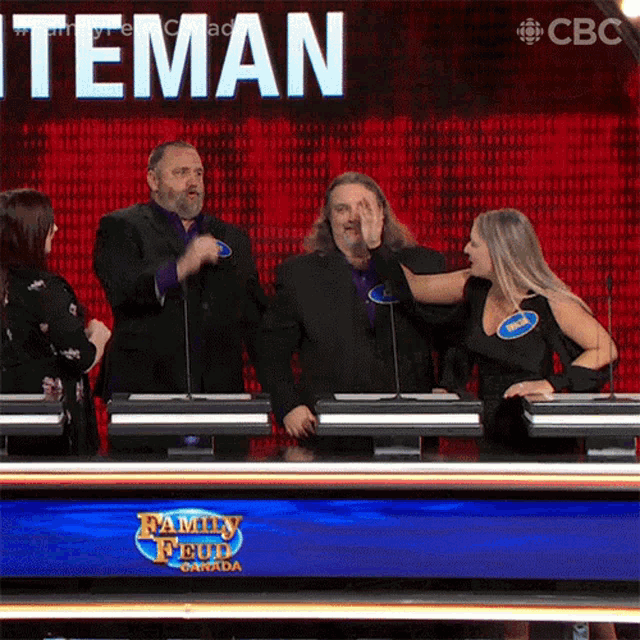 a group of people playing a game called family feud canada