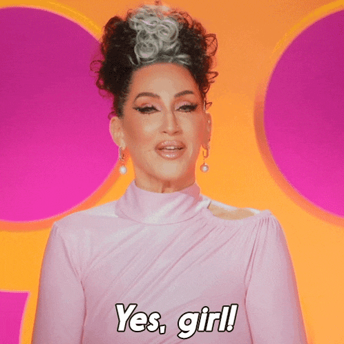 a woman wearing a pink dress says yes girl