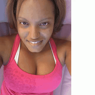 a woman wearing a pink tank top is smiling for the camera
