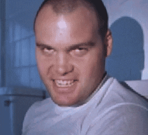 a bald man in a white shirt is making a funny face and smiling .