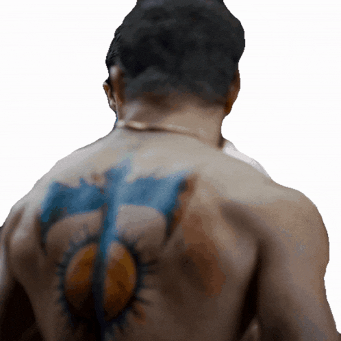 a man has a tattoo on his back that looks like a sun