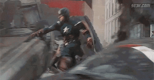 captain america is flying through the air while holding a shield over his head .