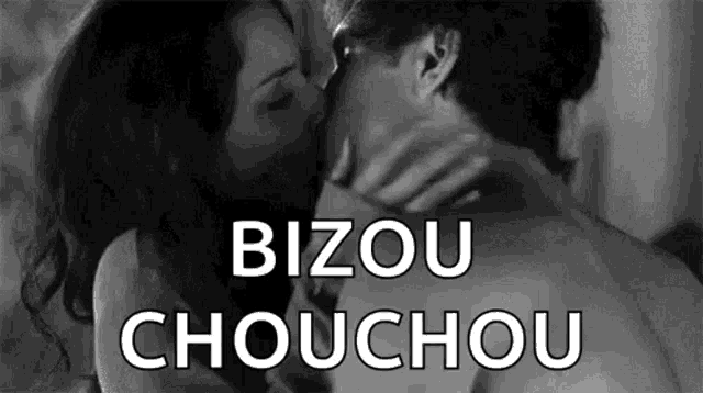 a man and a woman are kissing in a black and white photo with the words `` bizou chouchou '' .