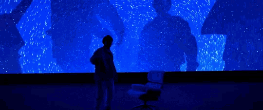 a silhouette of a person in front of a blue background
