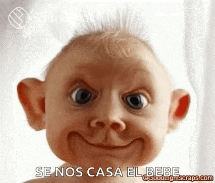 a baby is making a funny face with a big smile on its face .