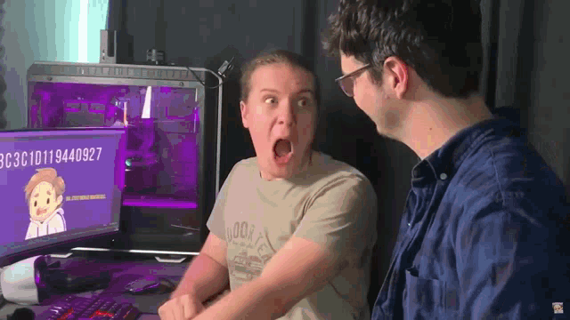 two men are sitting in front of a computer screen that says bc3c10d119494097