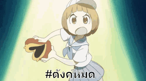 a girl in a sailor suit is holding a heart shaped object in her hand .