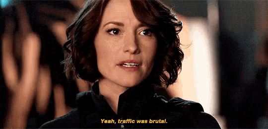 a close up of a woman 's face with the words `` yeah , traffic was brutal '' .