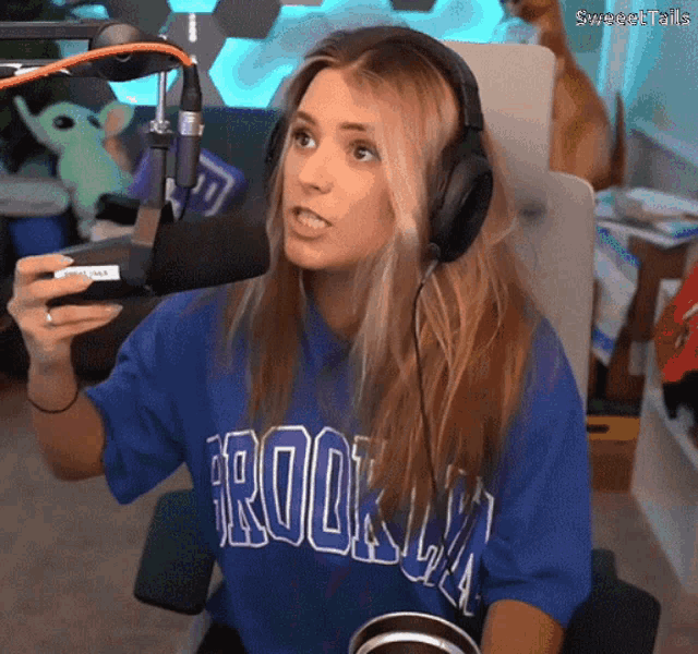 a woman wearing headphones and a brooklyn shirt