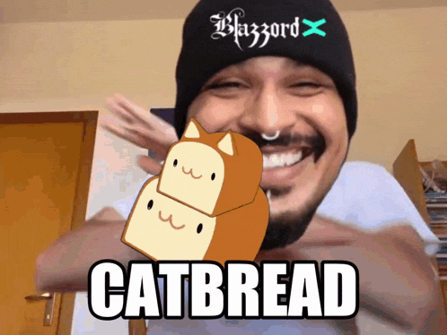 a man wearing a black beanie has a catbread sticker on his chest