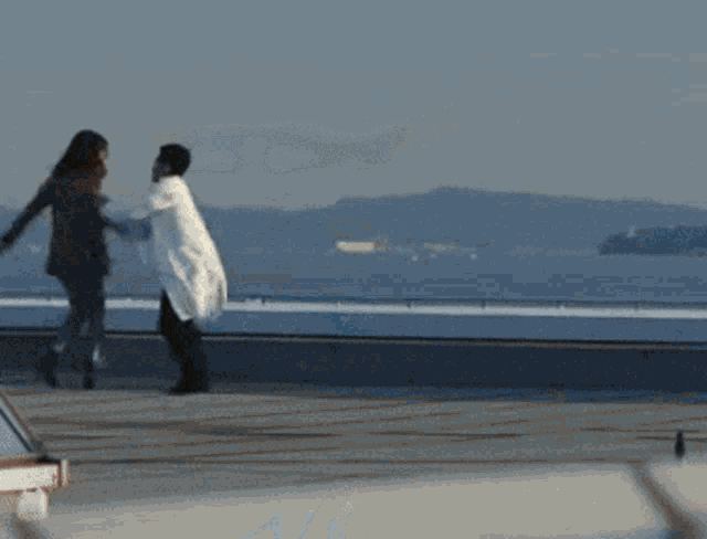 a man in a white coat is walking with another person