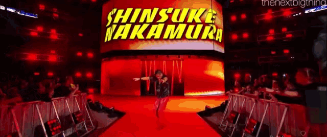 shinsuke nakamura is walking down the aisle of a wrestling arena