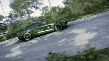 a green sports car is driving down a curvy road