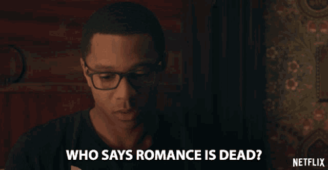 a man wearing glasses says " who says romance is dead "