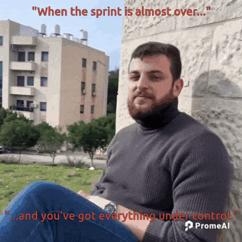 a man with a beard is sitting in front of a building with the words " when the sprint is almost over "