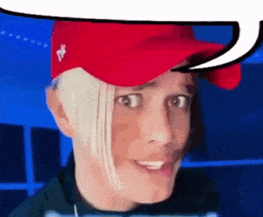 a man wearing a red hat is making a funny face with a speech bubble above his head .