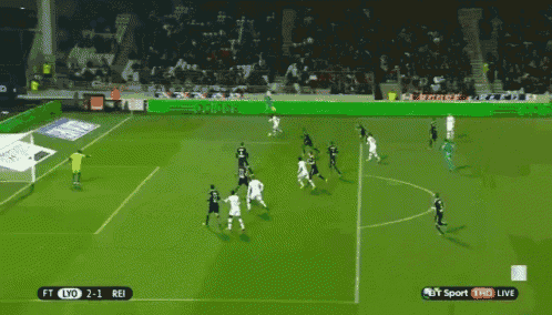 a soccer game is being played on a field with an adidas ad in the background