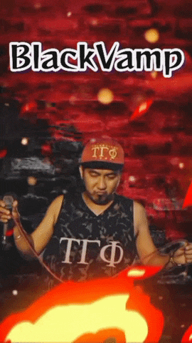 a man singing into a microphone in front of a red background that says black vamp