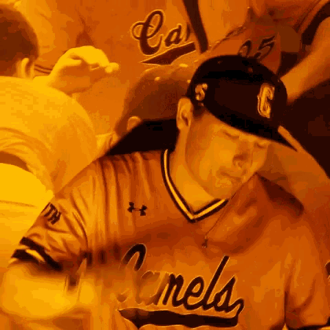 a man wearing a canels jersey looks down