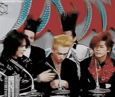 a group of young men are sitting in front of microphones with the caption " yoursweetvalo " at the bottom