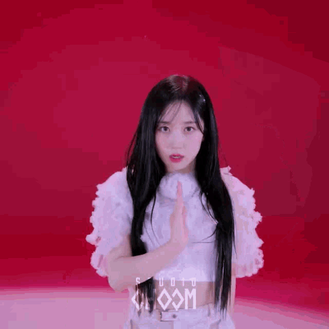 a woman in a white dress is dancing in front of a red background that says studio choom .