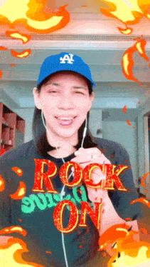a woman wearing a blue hat and a black shirt that says " rock on "