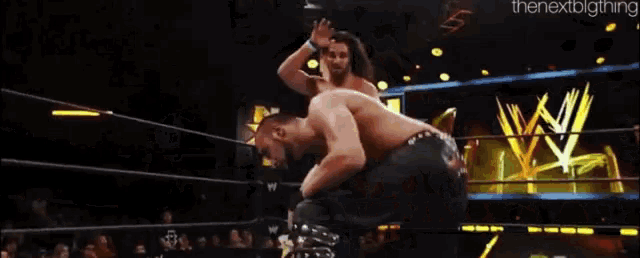 a blurry picture of wrestlers in a wrestling ring with the nextbigthing written in the corner
