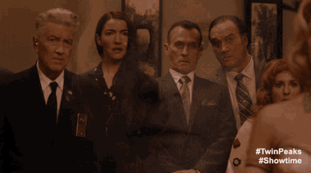 a group of people standing next to each other with #twinpeaks #showtime on the bottom right