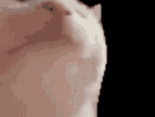 a close up of a man 's face with a black background