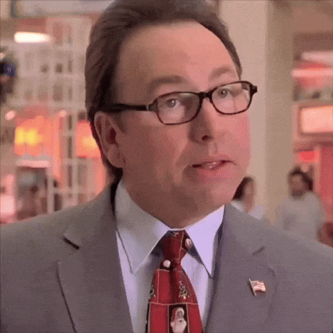 a man wearing glasses and a tie with a picture of a penguin