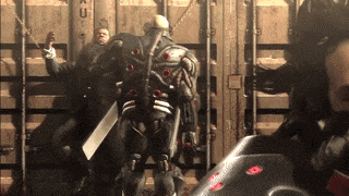 a robot with a sword is being attacked by a man in a suit