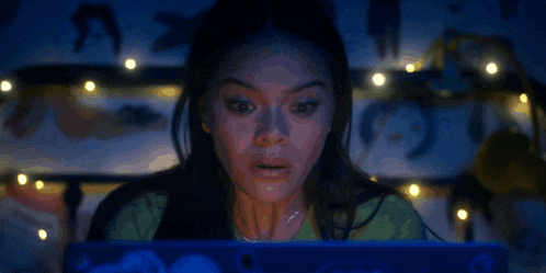 a woman with a surprised look on her face is using a laptop computer