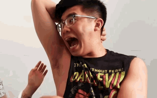 a man wearing glasses and a tank top that says thout fear dan evil