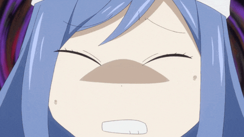 a close up of a girl 's face with a surprised look on her face