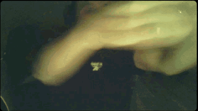 a close up of a person 's hands with the letter k on the bottom