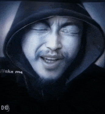 a man with his eyes closed wearing a black hoodie that says wake me