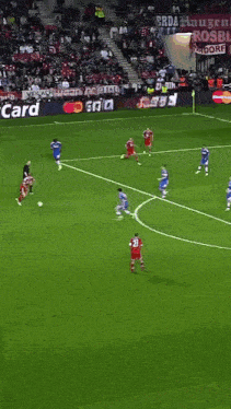 a soccer game is being played on a field that has adidas advertisements on the sidelines