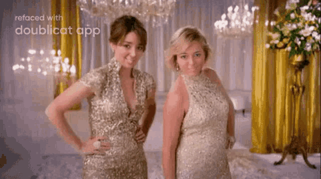 two women in gold dresses are standing next to each other in a room with chandeliers .